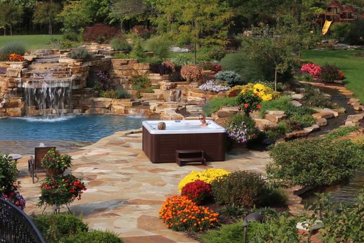 Hot tub next to cascading waterfall